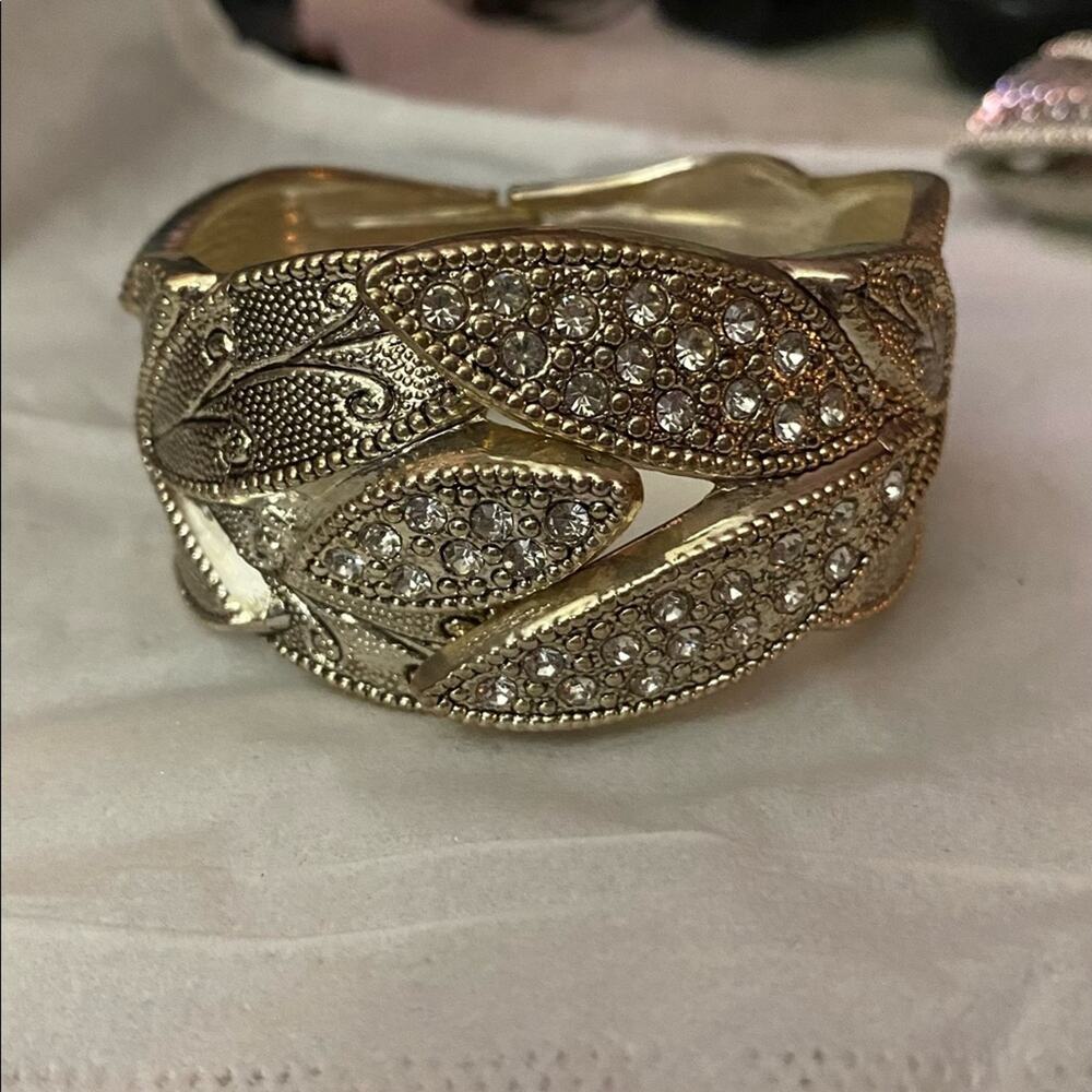 Silvertone bracelet with faux clear stones hinged closure intricate design